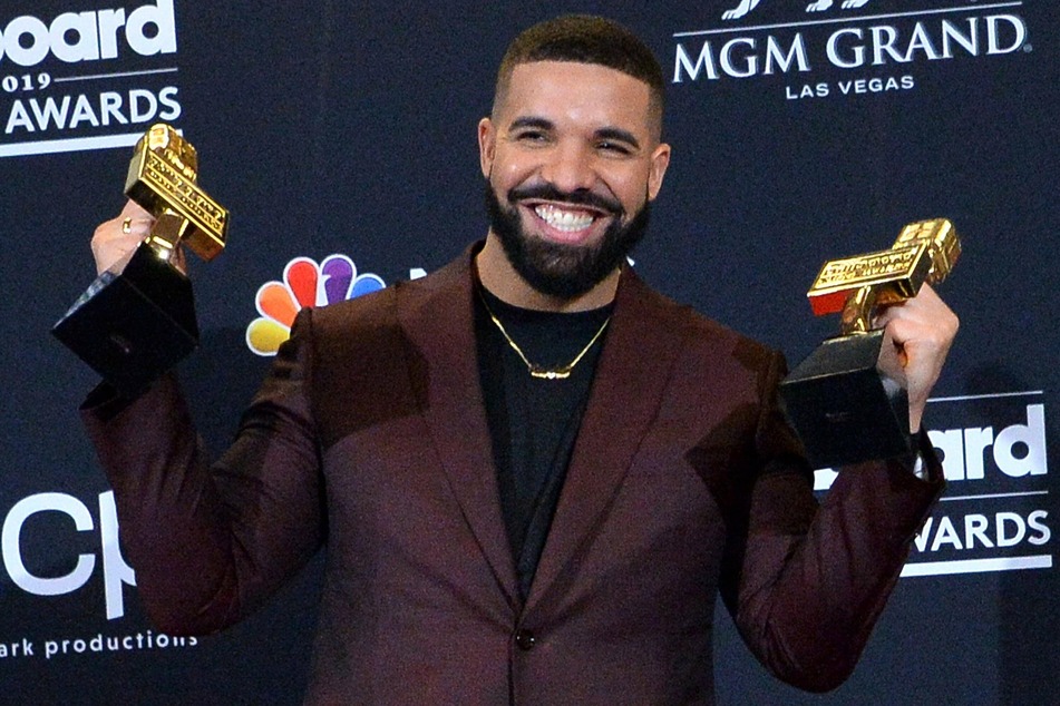 Canadian R&B star Drake poses with two of his twelve awards at the 2019 Billboard Music Awards.