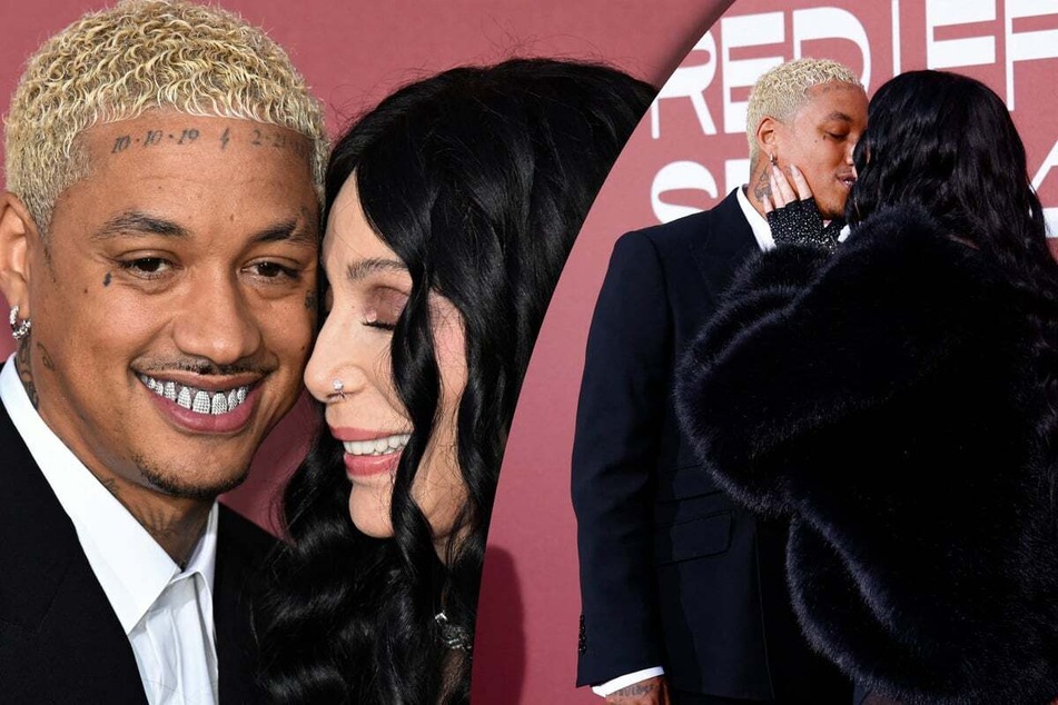 Cher (r.) and boyfriend Alexander "AE" Edwards packed on the PDA during their stroll on the red carpet of Thursday's amFAR AIDS Relief Gala.
