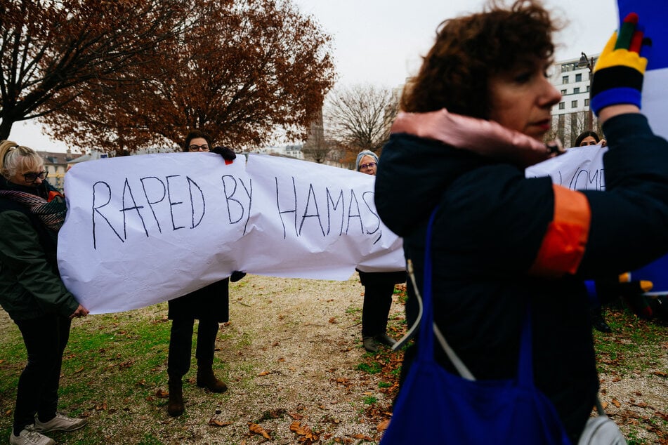 Demonstrators hold a banner reading "Raped by Hamas" during a rally organized by the Rape is Rape committee to "denounce the silence of international and feminist organizations" on rapes committed during the October 7 attacks, in front of Unesco headquarters in Paris on Friday.
