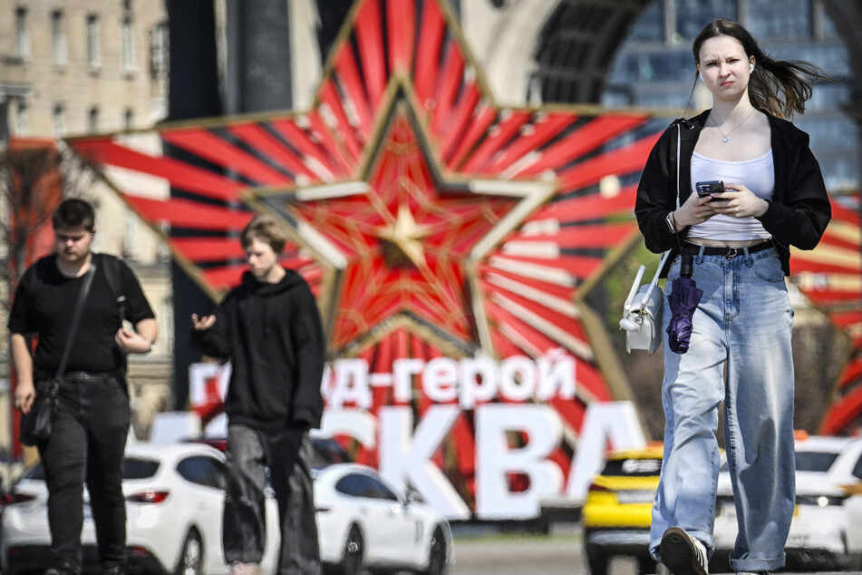 People walk past a decoration at Poklonnaya Hill in western Moscow on May 6, 2026, a few days ahead of the Victory Day military parade.