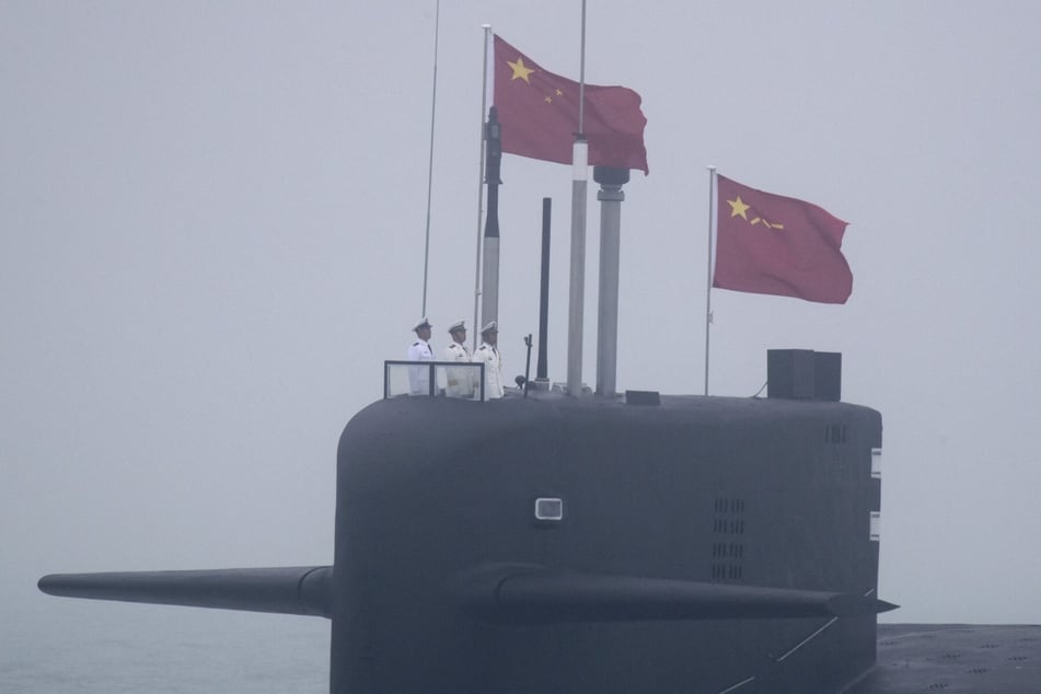 A nuclear submarine participates in a naval parade to commemorate the 70th anniversary of the founding of China's People's Liberation Arm Navy in the sea near Qingdao on April 23, 2019.