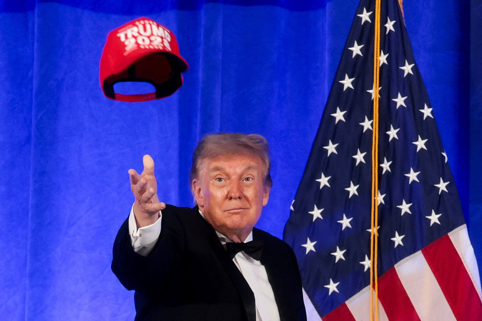 President Donald Trump throws a "Trump 2028" cap during mentalist Oz Pearlman's performance at the White House Correspondents' Association Dinner.