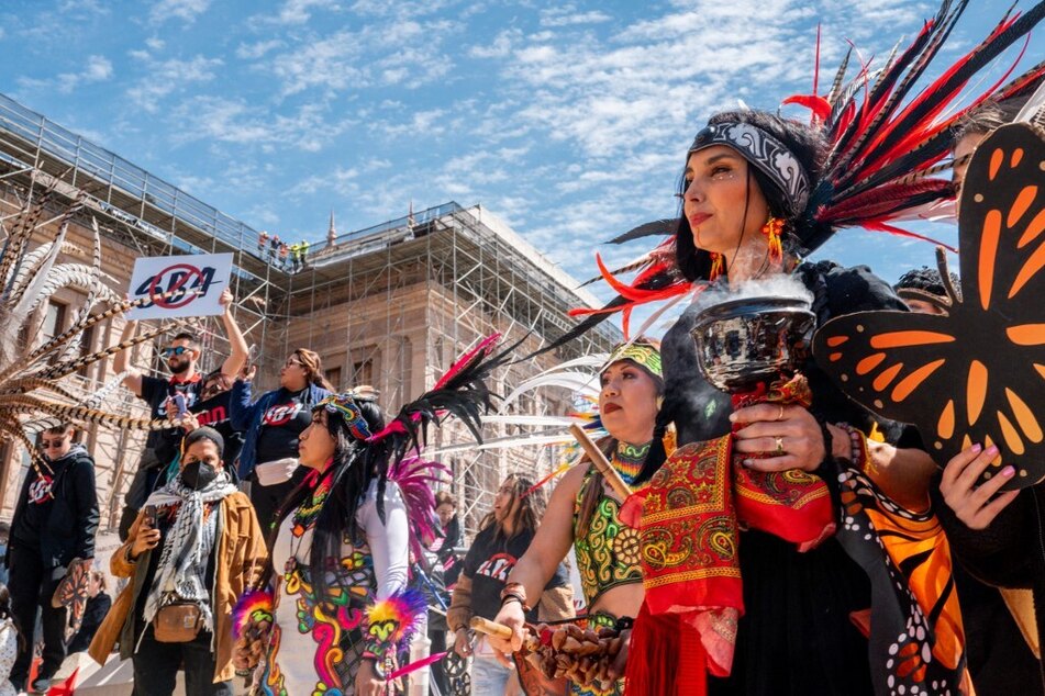 Members of the Ollinyolloti Danza Mexica group participate in a protest against Texas' Senate Bill 4 outside the State Capitol.