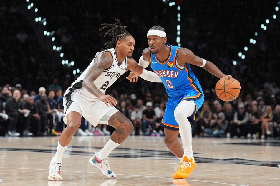 Oklahoma City Thunder guard Shai Gilgeous-Alexander dribbles against San Antonio Spurs guard Devin Vassell in the first half at Frost Bank Center.