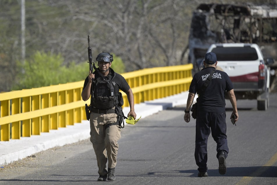 Mexican law enforcement patrol a bridge amid escalating cartel violence in February, 2026.