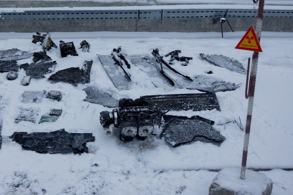 Parts of an explosive device at the New Safe Confinement, which protects the remains of reactor 4 of the former Chernobyl nuclear power plant to contain radiation, are pictured following a drone attack on February 14, 2025.