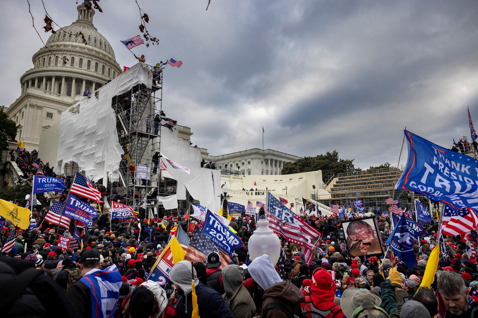 Prosecutors also more closely tied Trump to the events of January 6 (pictured), when his supporters stormed Congress in a bid to block Biden's election victory.