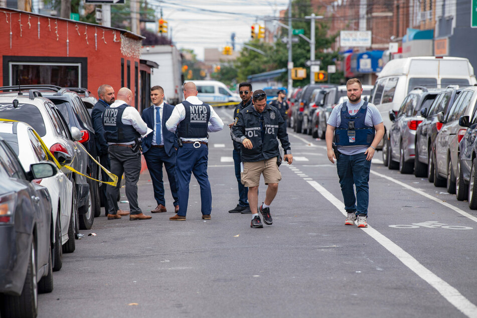 NYPD officers investigate the scene of the crime.