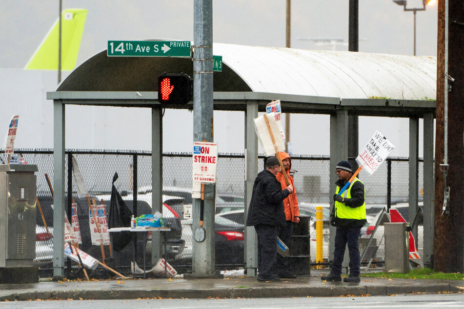 Boeing workers from the International Association of Machinists and Aerospace Workers District 751 gather on a picket line on the day that union members vote on a new contract proposal, in Seattle, Washington.