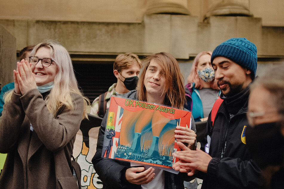GCOP protesters give the UK Polluter Award to energy firm Drax as part of their COP26 demonstrations.