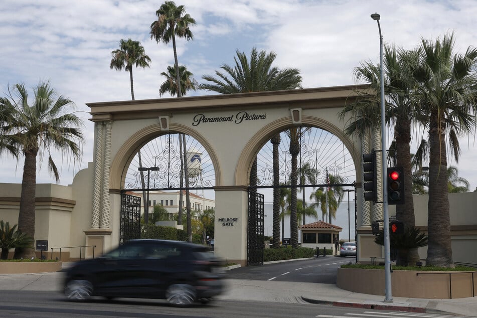 A car drives by the main gate at the Paramount Studios lot on July 13, 2026 in Los Angeles, California.