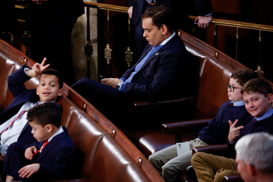 New York Representative-elect George Santos sits alone in the House Chamber on the first day of the 118th Congress.