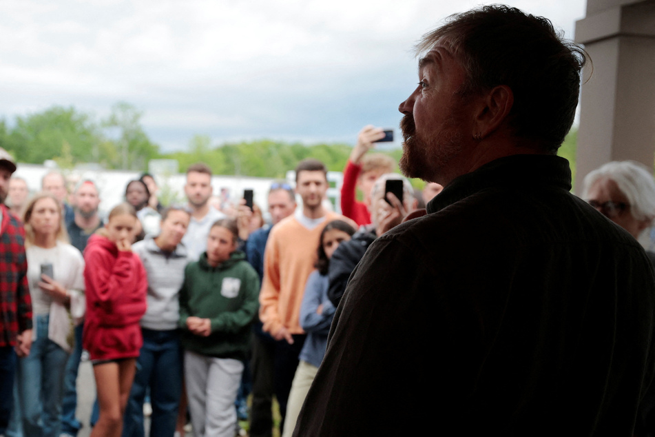 Graham Platner talks to the crowd outside his campaign town hall meeting in Portland, Maine, on June 7, 2026.