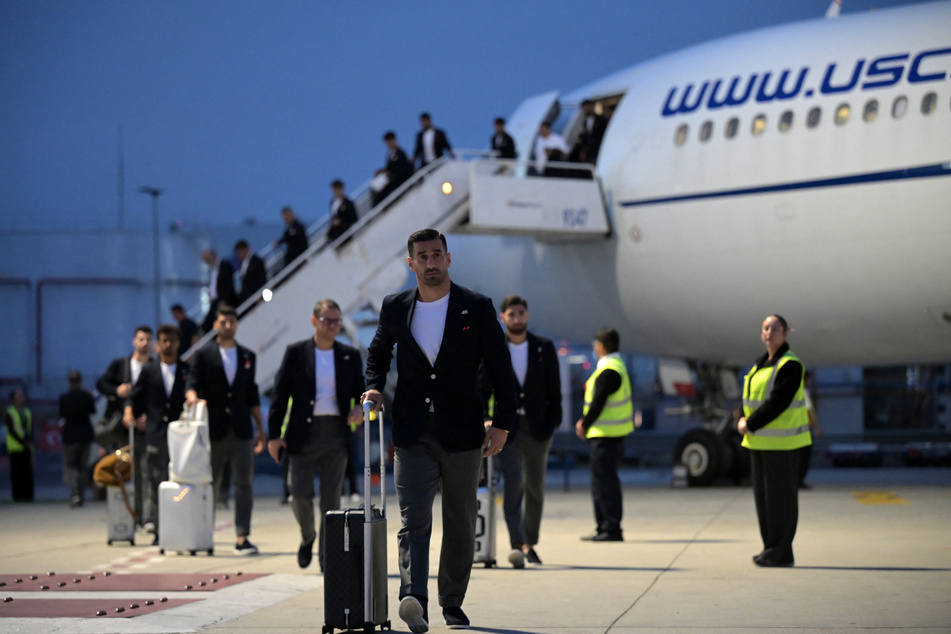 Iran's captain Ehsan Hajsafi and teammates walk on the tarmac upon their arrival at the Tijuana International Airport in Mexico on June 7, 2026.