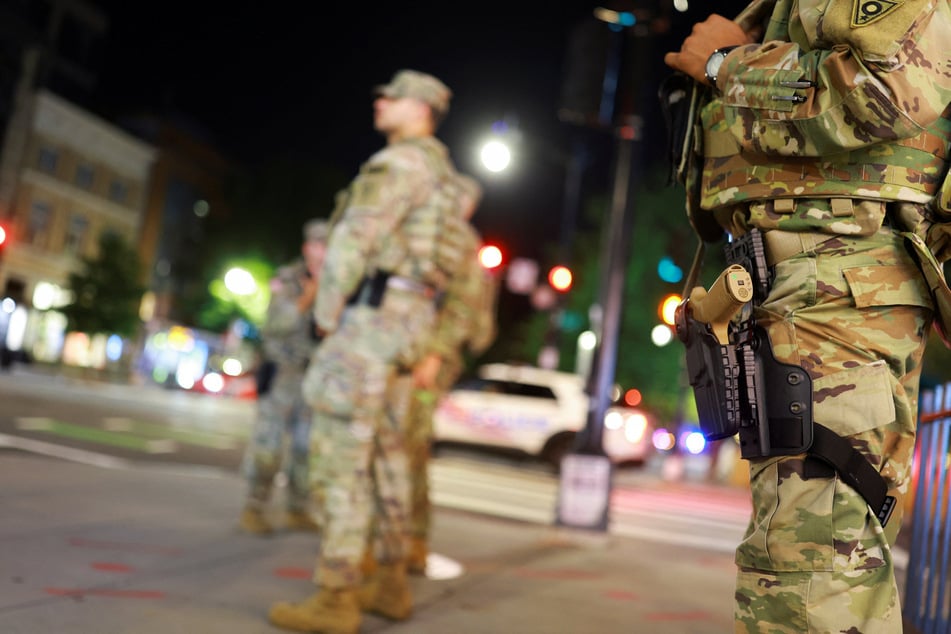 National Guard troops begin carrying weapons in Washington DC