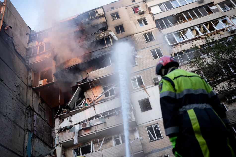 A firefighter works at a heavily damaged residential building following Russian drone and missile strikes in Kyiv on September 7, 2025.