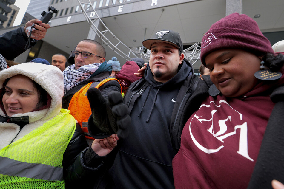Kilmar Abrego Garcia is greeted by supporters as he leaves a check-in at the US Immigration and Customs Enforcement Baltimore Field Office on December 12, 2025.