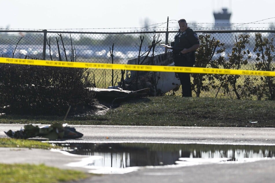 First responders examine debris at the site of the accident.