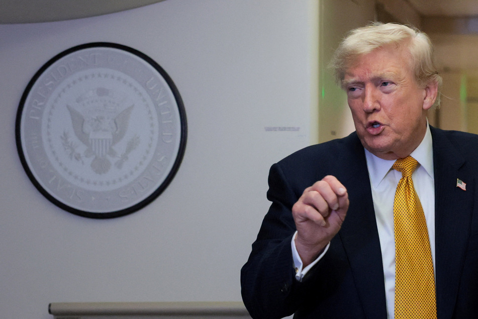 President Donald Trump speaks to reporters mid-flight in the press cabin of the new, Qatari-gifted Air Force One after changing planes to return to Washington from Britain's RAF Mildenhall on July 8, 2026.