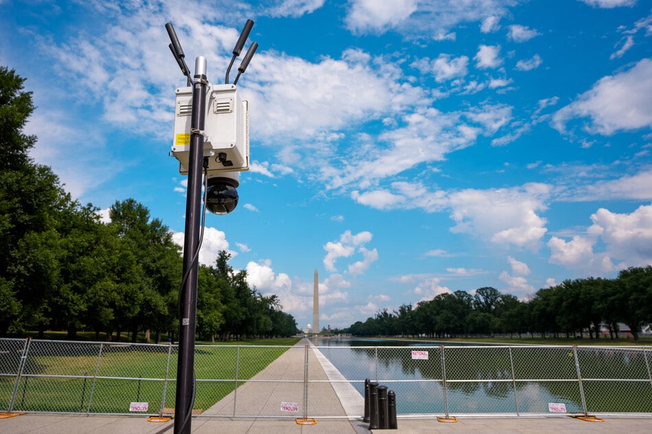 The Washington Monument is visible behind a security camera set up at the edge of the Reflecting Pool on the National Mall on July 9, 2026, in Washington, DC.