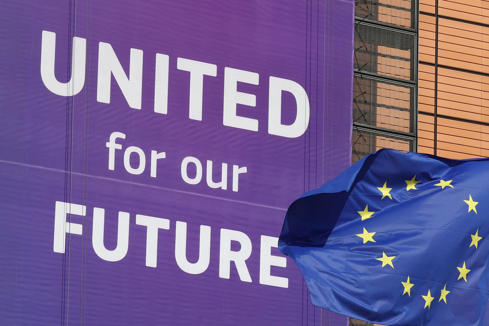 A European Union flag flutters outside the European Commission headquarters in Brussels, Belgium.