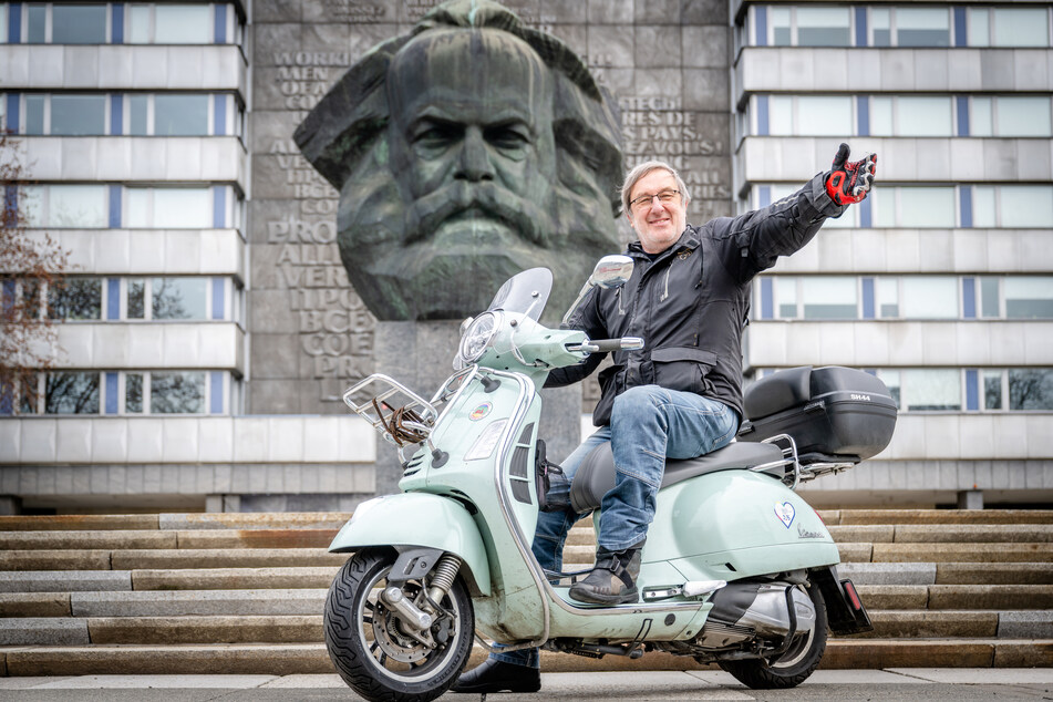 Bernd Rippert (65) poses with his Vespa in front of the Karl Marx head.