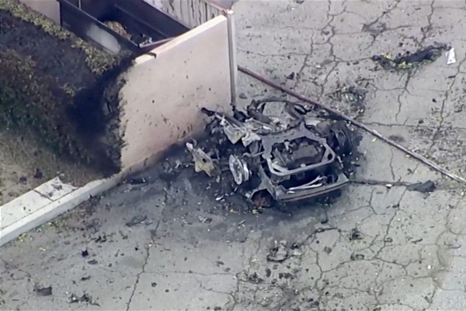 A destroyed car remains after a bomb exploded near a reproductive health facility in Palm Springs, California, on May 17, 2025.