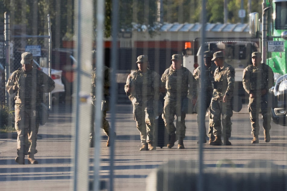 National Guard members walk outside the ICE Broadview facility in Chicago, Illinois, on October 9, 2025.