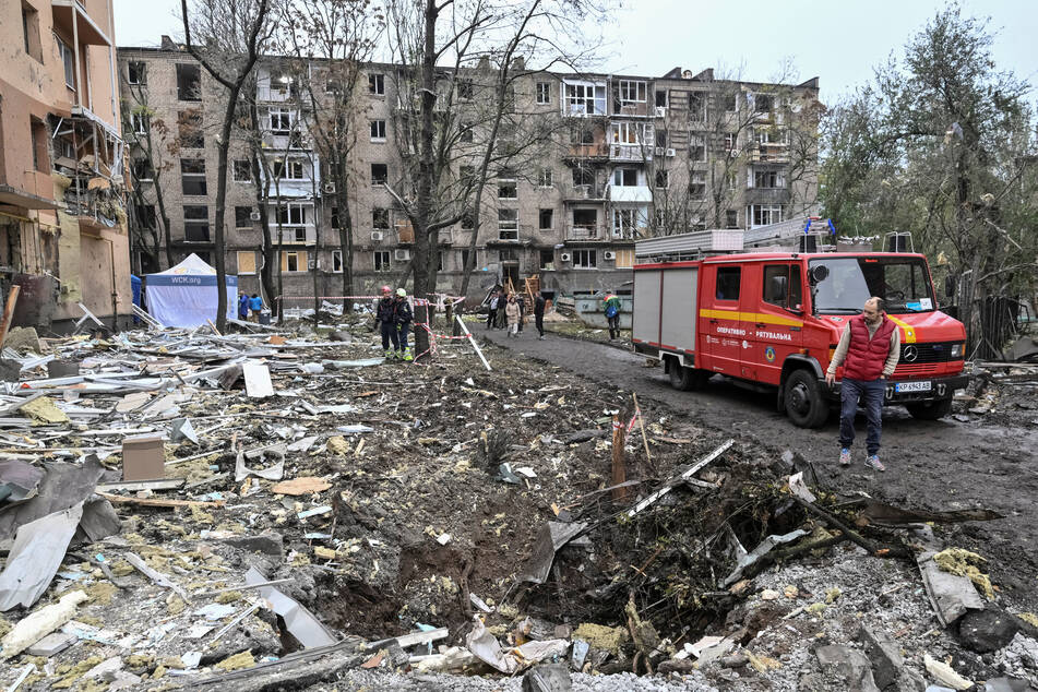 A resident looks at a crater that appeared at the site of an apartment building damaged during a Russian air strike in Zaporizhzhia, Ukraine, on October 17, 2026.