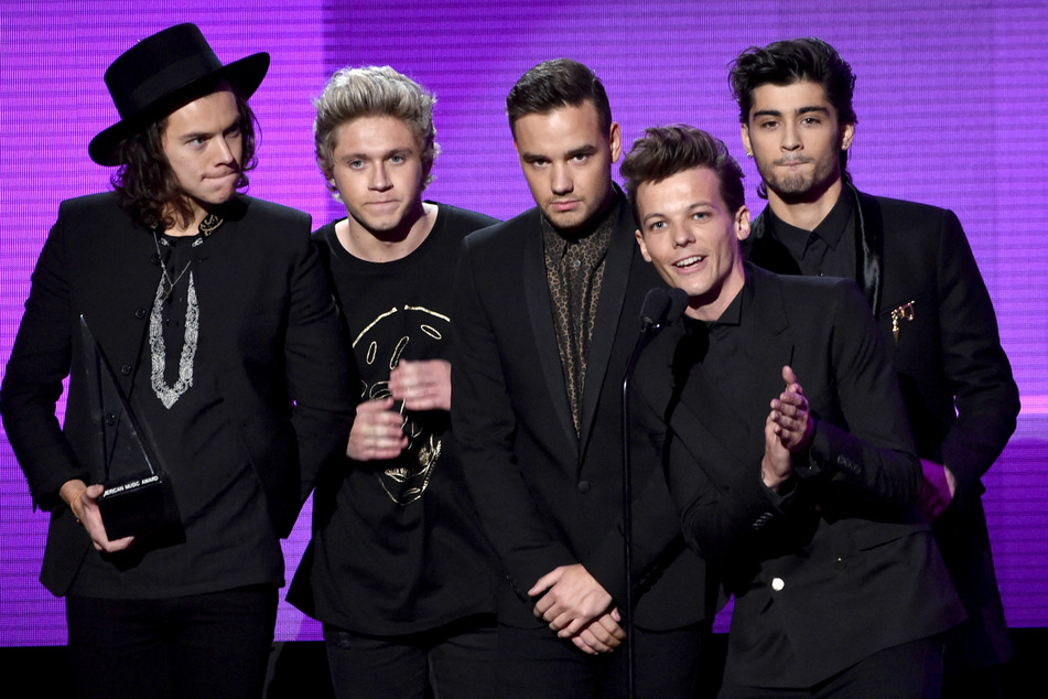 On May 26, Harry Styles (far l), Niall Horan (second from l), and Louis Tomlinson (second from r) all performed One Direction songs during their concerts.