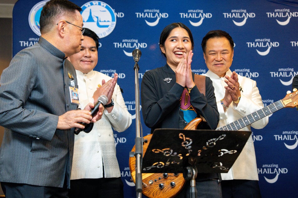 Nene Royal (second from r.) stands next to Thailand's Prime Minister Anutin Charnvirakul (r.) at the Government House in Bangkok on July 14, 2026. The 16-year-old is a music sensation in her home country.