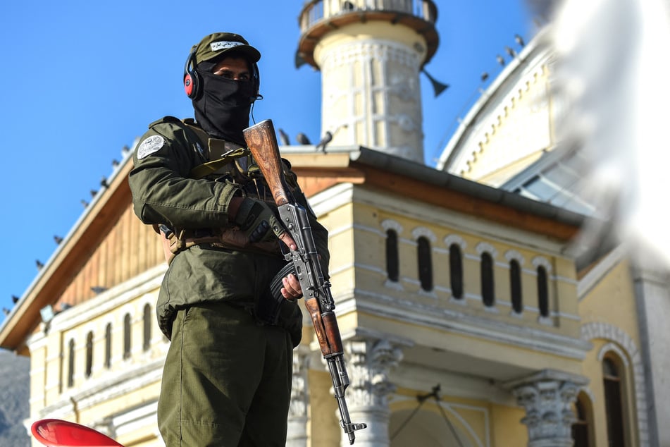 A Taliban security personnel stands guard outside the Shah-Do Shamshira Mosque during Eid al-Fitr prayers, which marks the end of the holy fasting month of Ramadan in Kabul on March 30, 2025.