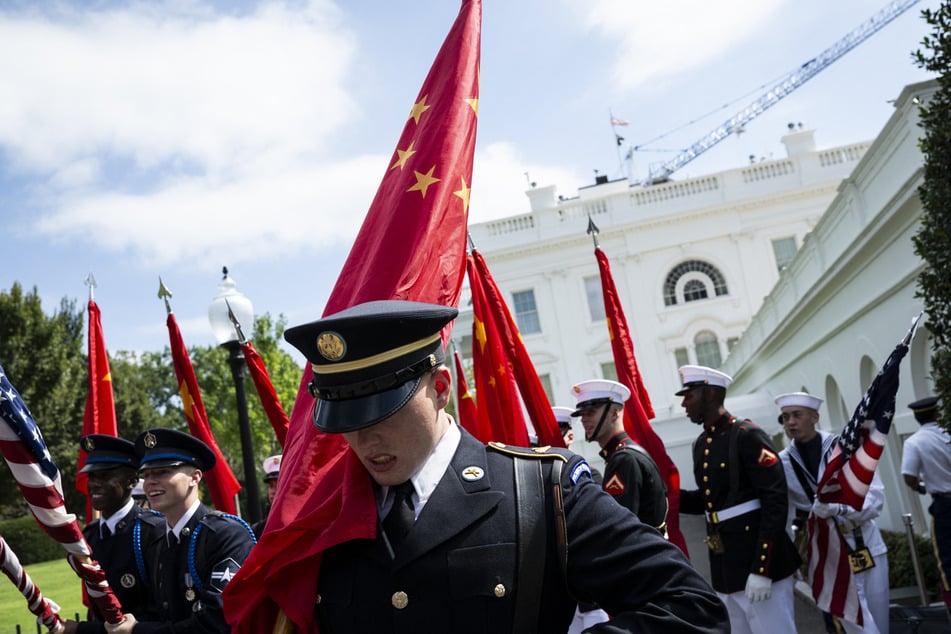 A US Military Honor Guard rehearses with US and Chinese flags outside the White House ahead of a visit by Chinese President Xi Jinping this week.