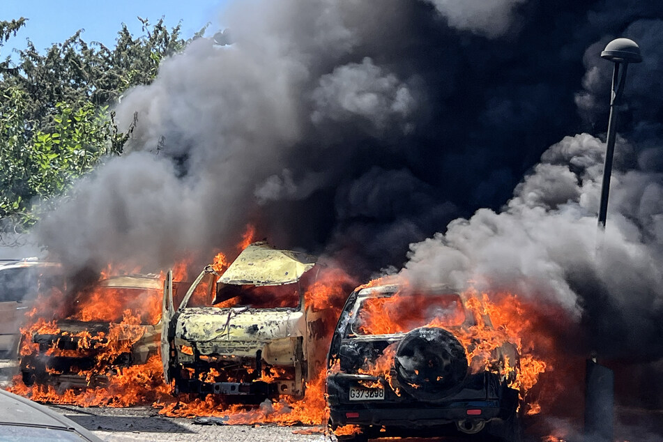 Vehicles are engulfed in flames and smoke following an Israeli airstrike on southern Lebanon last week.