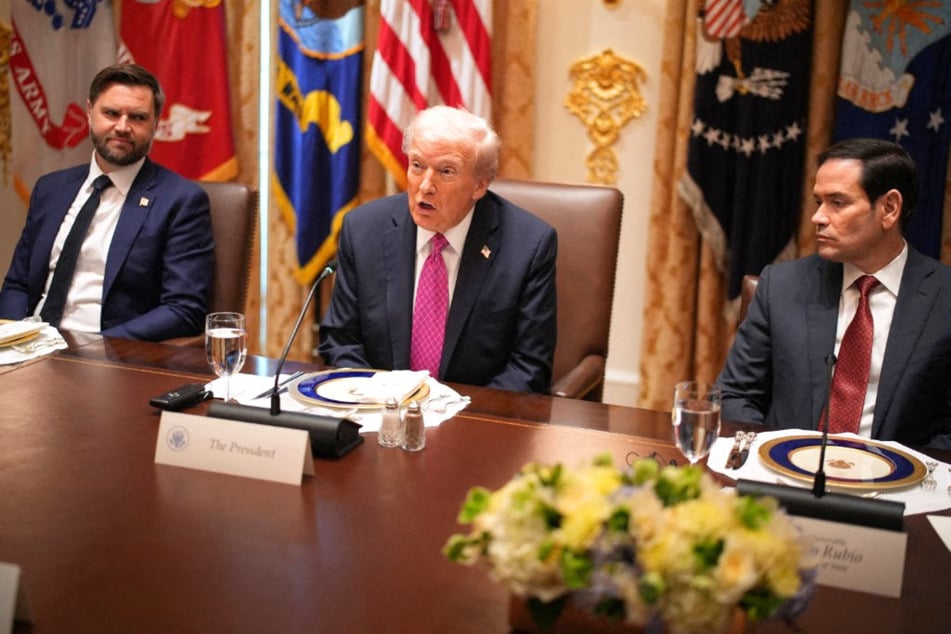 President Donald Trump's (c) closest officials have reportedly been warning him that his war with Iran may take longer than he anticipated. The president initially claimed it would only be a matter of weeks, but the conflict has now lasted several months.