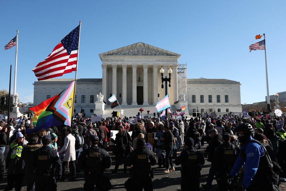 Transgender rights supporters and opponents rally outside of the US Supreme Court as the high court hears arguments in a case on transgender health rights on December 04, 2024 in Washington, DC.