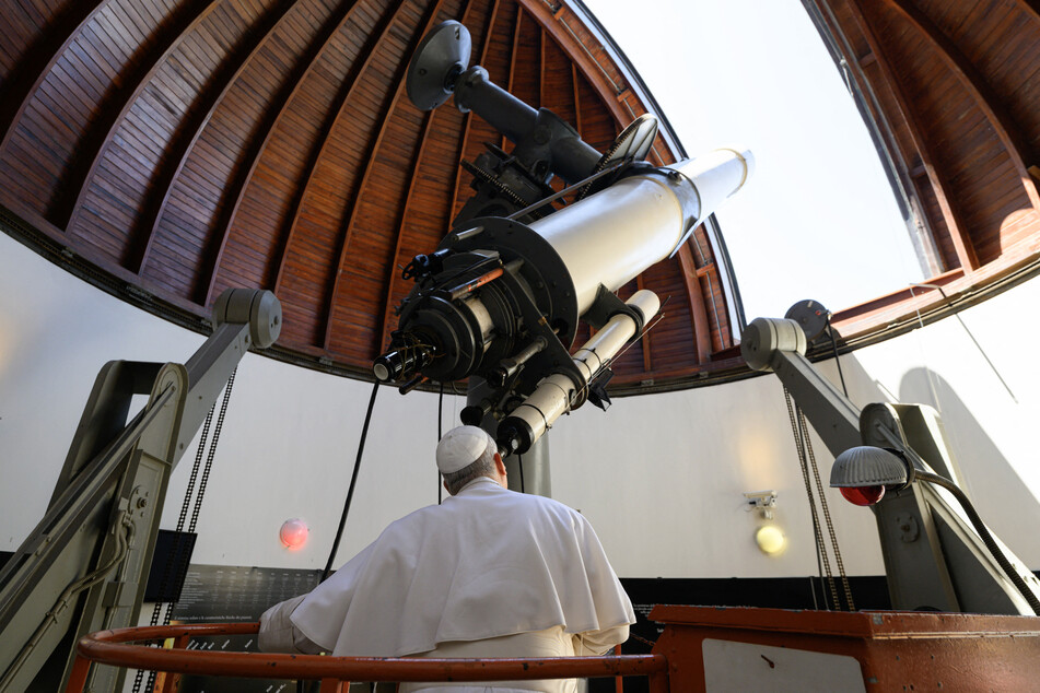 Pope Leo XIV looks through a telescope during his visit at the Vatican Observatory, Specola in the summer papal estate in Castel Gandolfo.