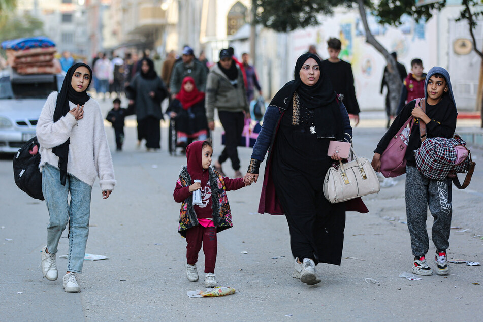 Residents of the refugee camp of Bureij arrive in Deir al-Balah in the central Gaza Strip following an evacuation order, on December 22, 2023.
