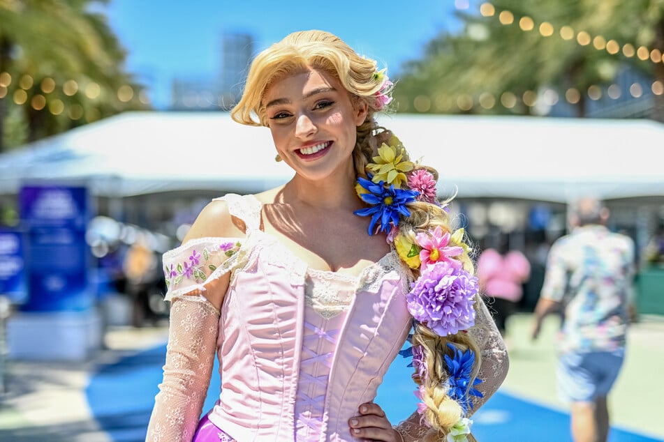 Cosplayers attend D23: The Ultimate Disney Fan Event outside the Anaheim Convention Center in California on August 14, 2026.