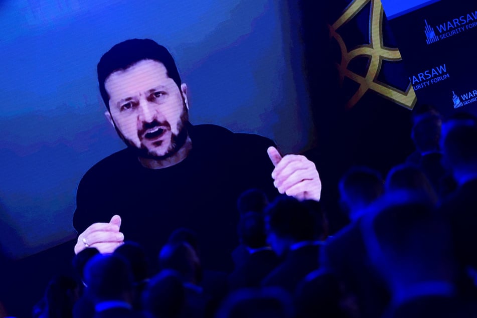 Ukraine's President Volodymyr Zelensky appears on screen as he speaks during the Warsaw Security Forum in Poland on October 12, 2026. President Donald Trump has called for his removal.