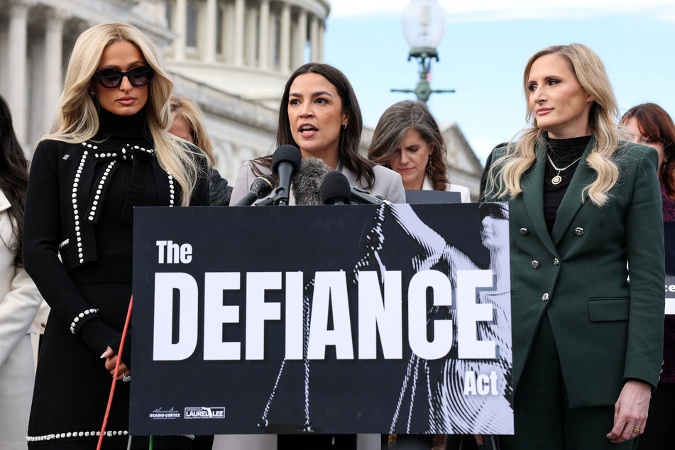 Paris Hilton (l.) joins Representatives Alexandria Ocasio-Cortez (c.) and Laurel Lee to advocate for passage of the DEFIANCE Act during a press conference on Capitol Hill on January 22, 2026.