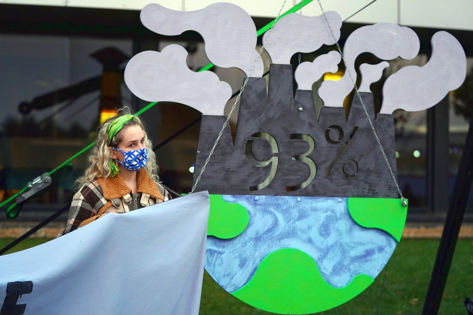 A protester on November 4 in Glasgow points out that the richest countries pollute the most, but poor countries suffer the consequences.
