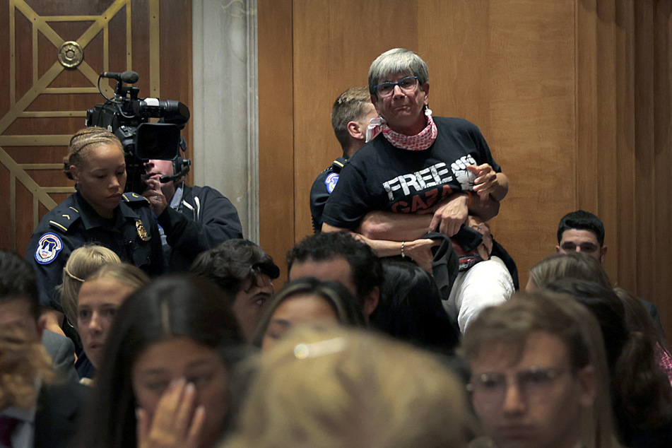 Kathy Gannett, wearing a "Free Gaza" shirt, is removed as Secretary of State Marco Rubio speaks during a Senate Foreign Relations Committee hearing.