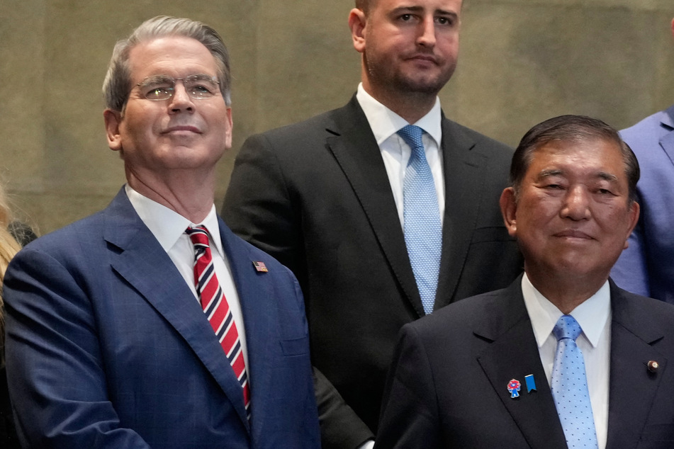 Japanese Prime Minister Shigeru Ishiba (r.) shakes hands with US Treasury Secretary Scott Bessent before their meeting at the prime minister's office in Tokyo on Friday.