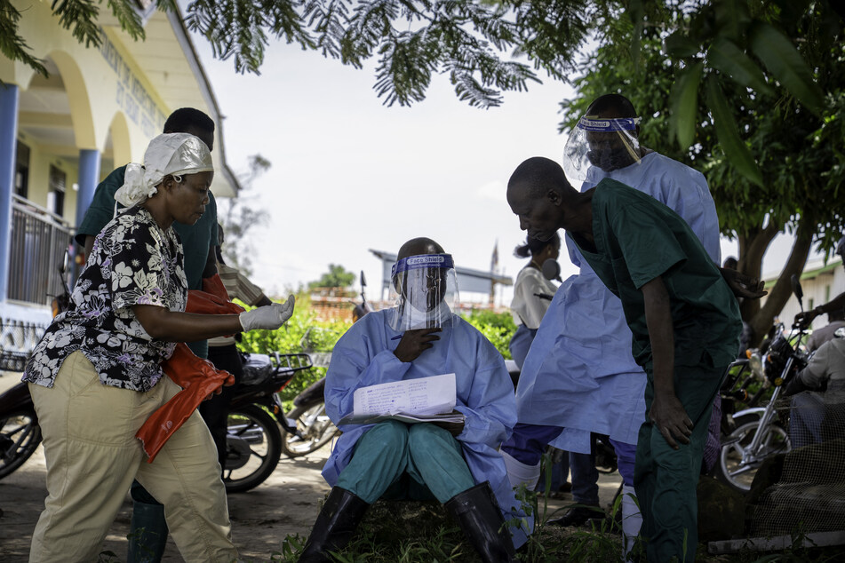 Dieudonné Sezabo, a health worker, shows his colleagues the list of patients at Rwampara Hospital in Ituri, in the eastern Democratic Republic of the Congo, on May 26, 2026.