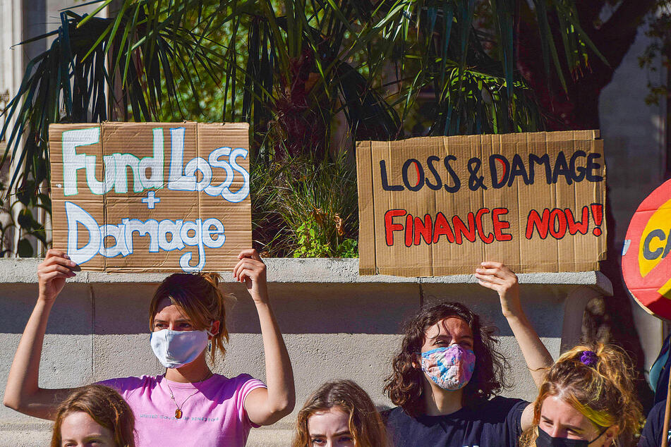Protesters hold placards calling for loss and damage finance during the demonstration in the UK as part of the Fridays For Future global climate strike, calling on the government to act urgently on the climate crisis.