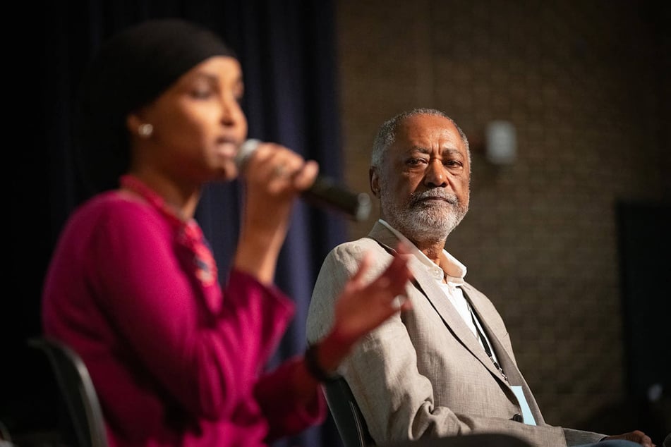 Democratic primary challenger Don Samuels (r.) listens to Congresswoman Ilhan Omar (l.) during the Q&A portion of the Minnesota fifth congressional district's DFL endorsing convention at South High School in Minneapolis.