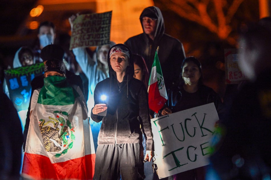 Protesters demonstrate against federal immigration raids outside the Department of Homeland Security office in Charlotte, North Carolina, on November 16, 2025.
