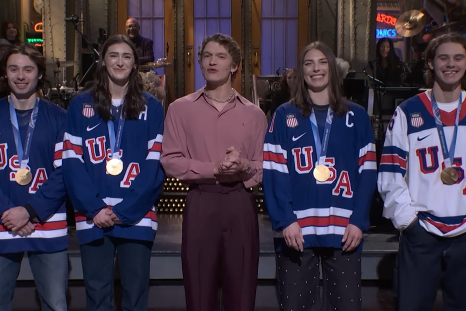 Heated Rivalry star Connor Storrie (c.) welcomed members of men's and women's Olympic hockey teams during his SNL opening monologue.