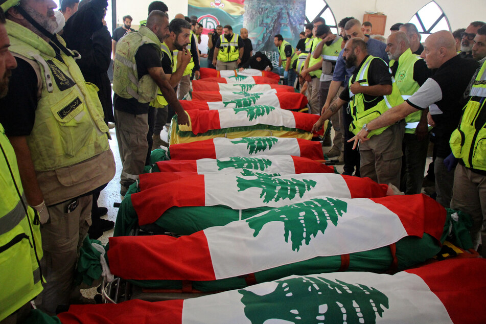 The bodies of people killed in Israeli strikes are seen wrapped in Lebanon's flags before the funeral in Tyre on May 28, 2026.